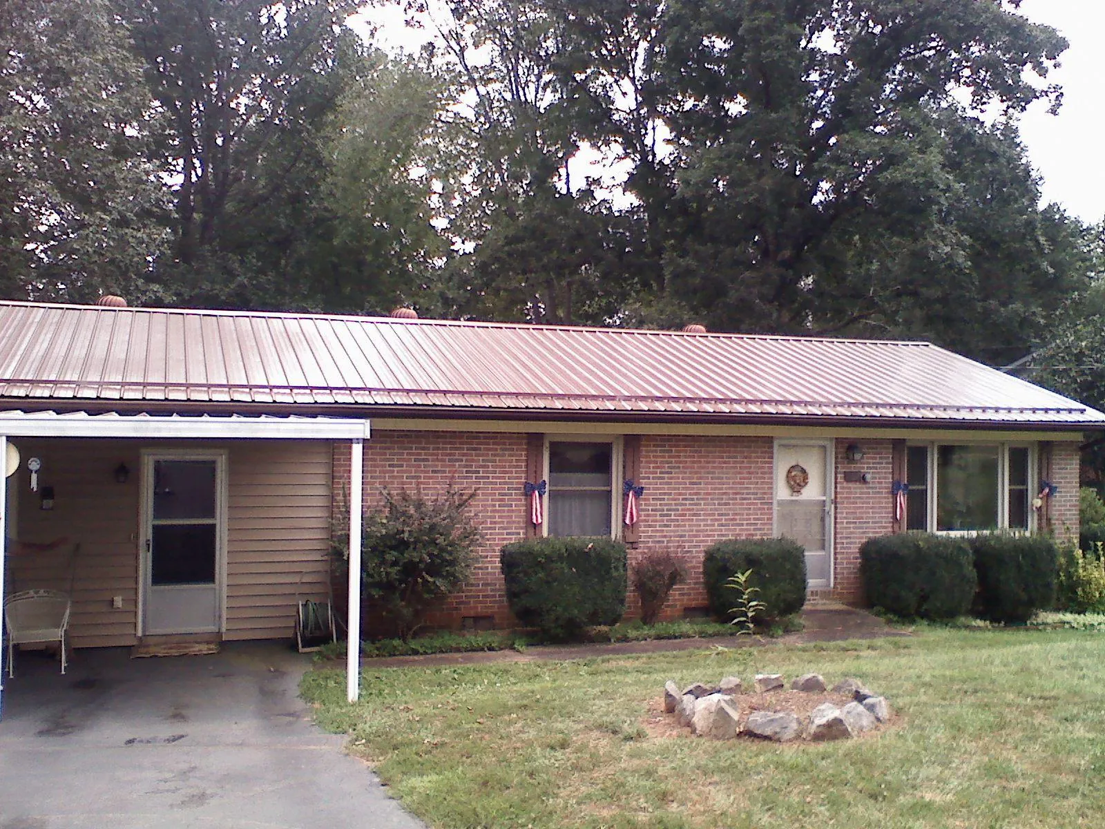 Bronze metal roof and carport on a brick ranch home — Roof Repair work by our crew in Ashton